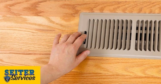 A homeowner checking their vents.