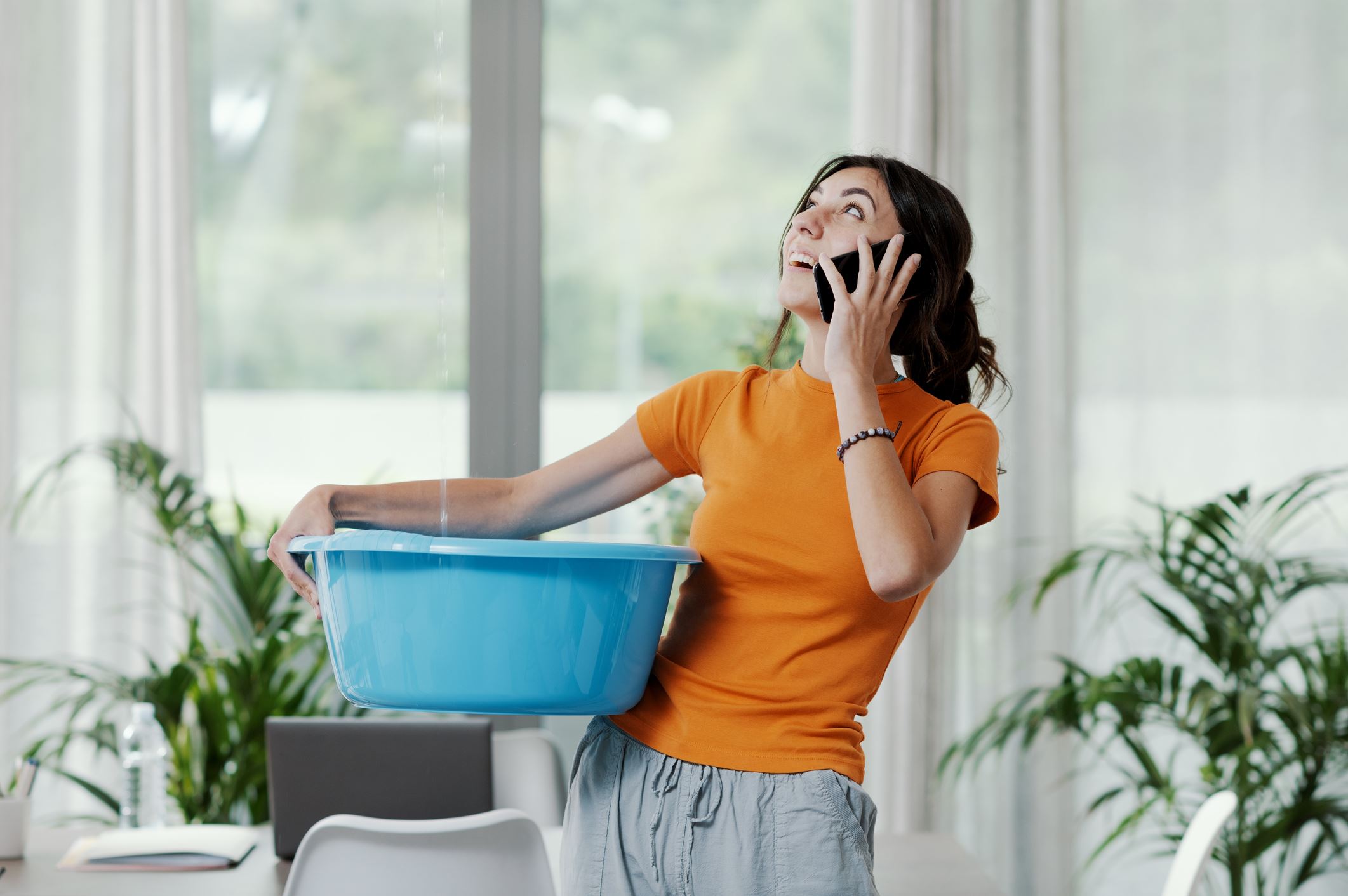 Homeowner on the phone with leaking repair service